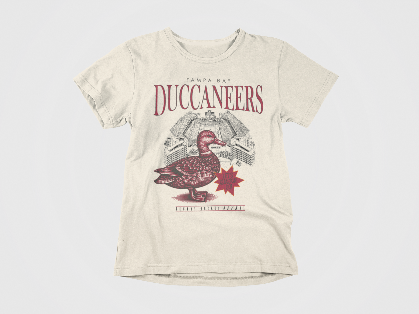 Front of Shirt, Cream colored shirt, Lettering says Tampa Bay Duccaneers, Lets Quackin' Go, Ducky! Ducky! Ducky!, Image of a Duck with Raymond James Stadium, Tampa Bay Buccaneers, Duck