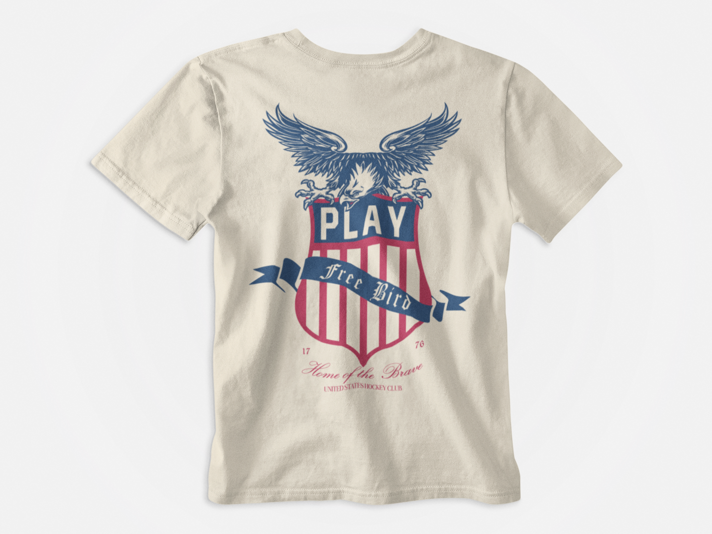 Back of Shirt, Cream colored, Says Play Free Bird over the USA Hockey Crest with an American Eagle, At the bottom of the shirt it says Home of the Brave, United States Hockey Club