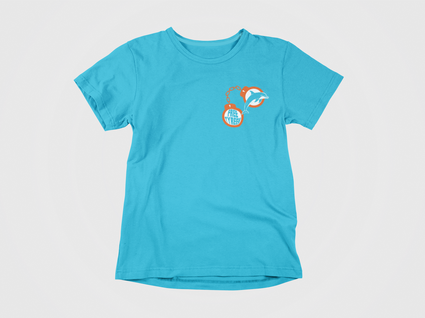 Teal colored shirt, front of shirt, orange handcuffs, free tyreek, dolphin in handcuffs, miami dolphins, fins