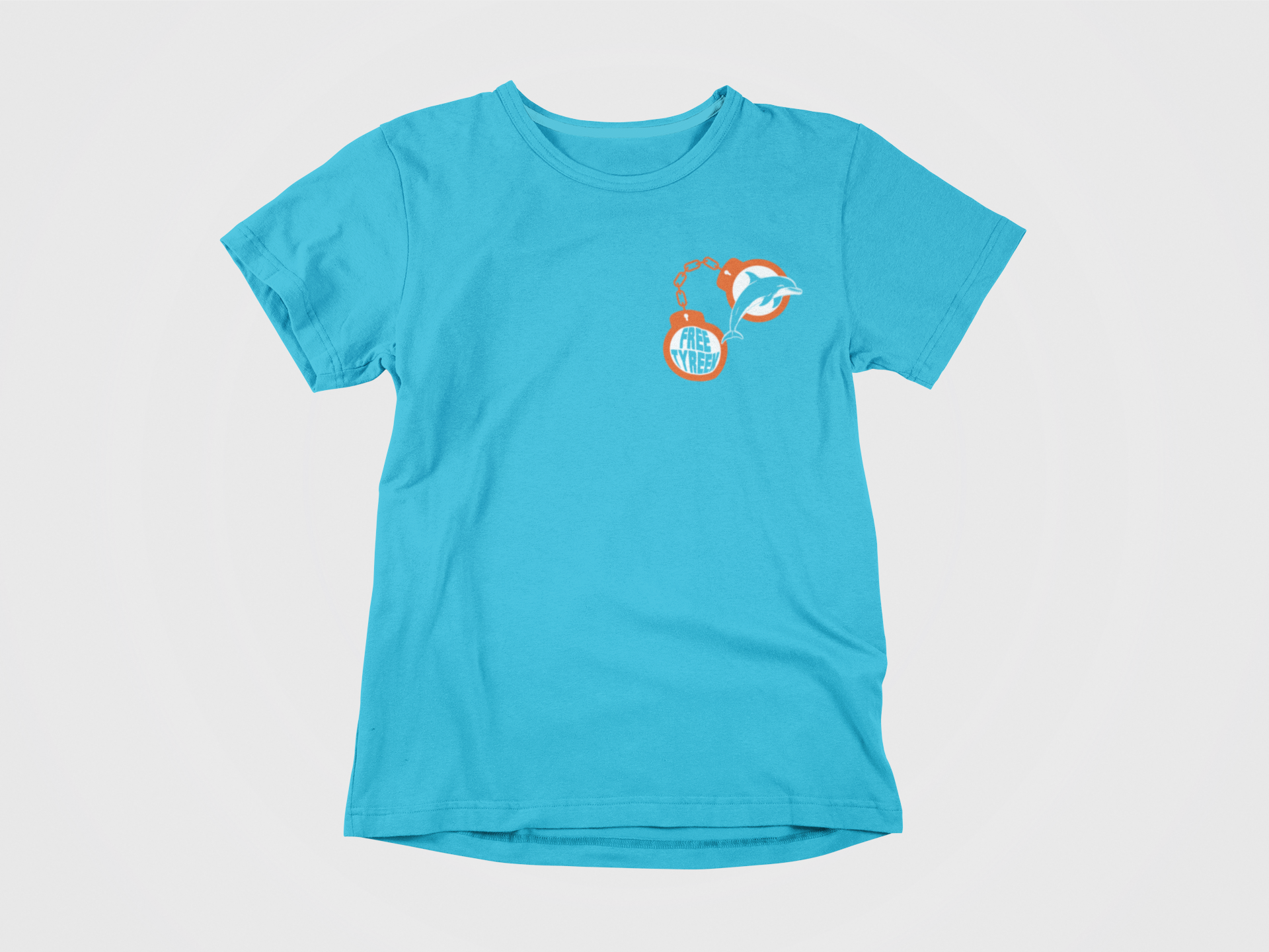 Teal colored shirt, front of shirt, orange handcuffs, free tyreek, dolphin in handcuffs, miami dolphins, fins