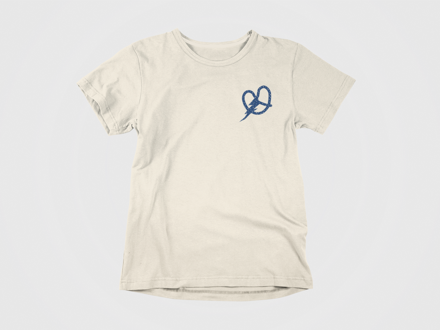 Front of shirt, cream colored shirt, image of a pretzel with a lightning bolt located in the pocket area.