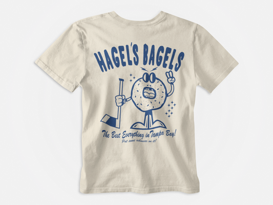 back of shirt, cream colored, blue font, hagel's bagels, bagel holding a hockey stick cartoon, the best everything in tampa bay, brandon hagel, tampa bay lightning, bolts