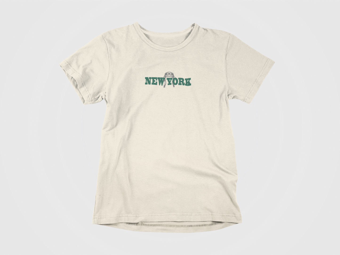 Front of shirt, Cream color, New York written in green, image of old pilot helmet in grey, new york jets, gang green