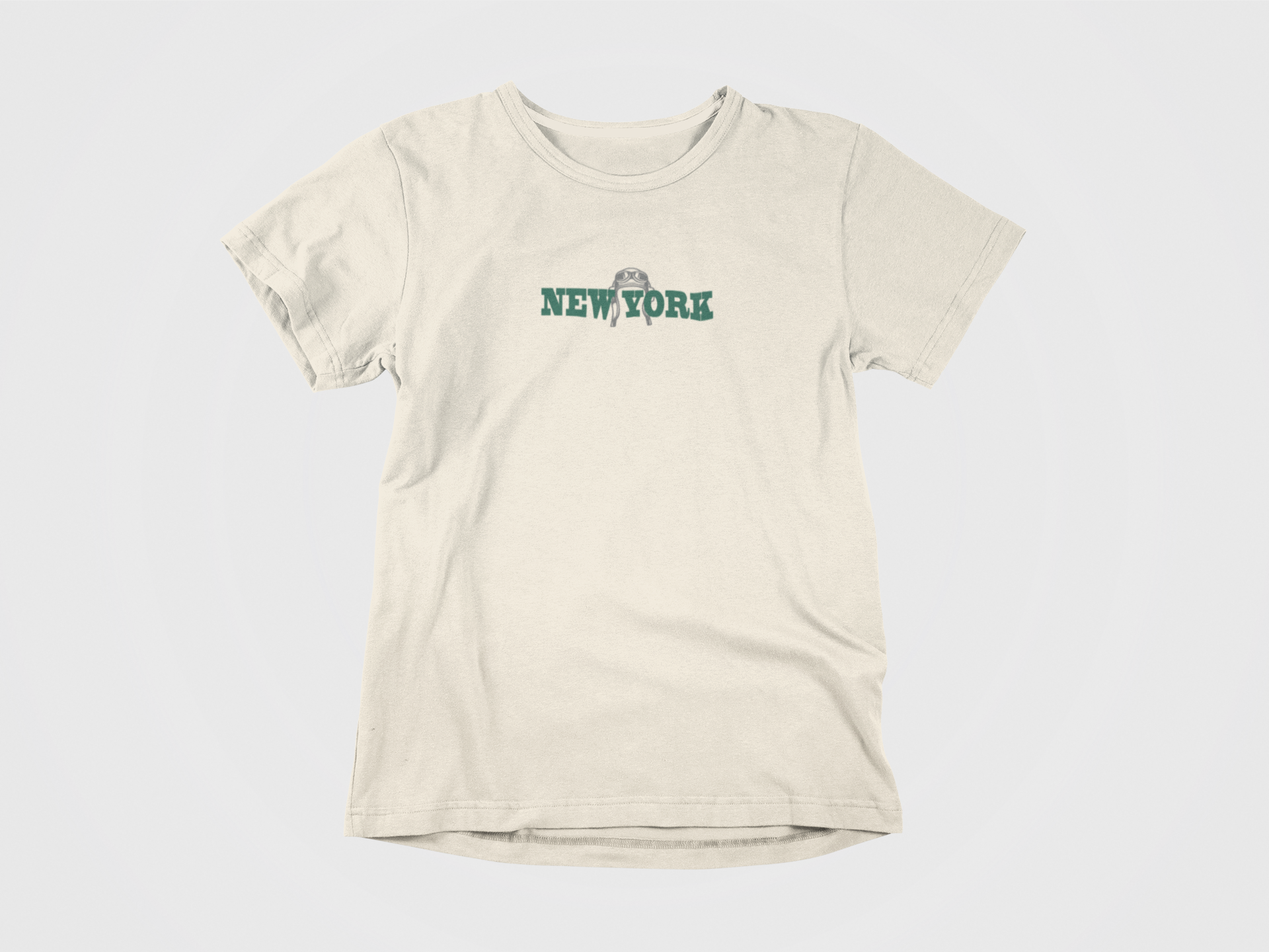 Front of shirt, Cream color, New York written in green, image of old pilot helmet in grey, new york jets, gang green