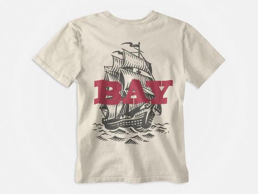 back of shirt, creme colored shirt, bay written in red with pirate ship, tampa bay buccaneers, fire the cannons, bay