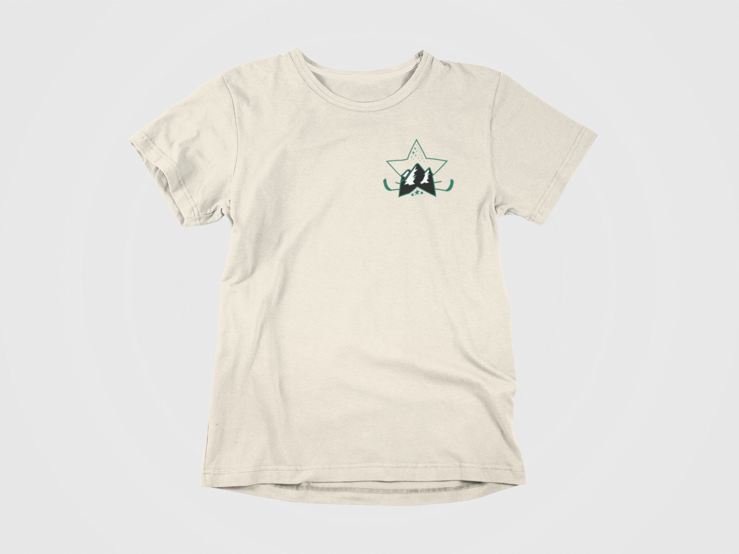 front of shirt, cream colored shirt, green lettering, pavelski lodge, star with mountains, joel pavelski, dallas stars, pocket logo